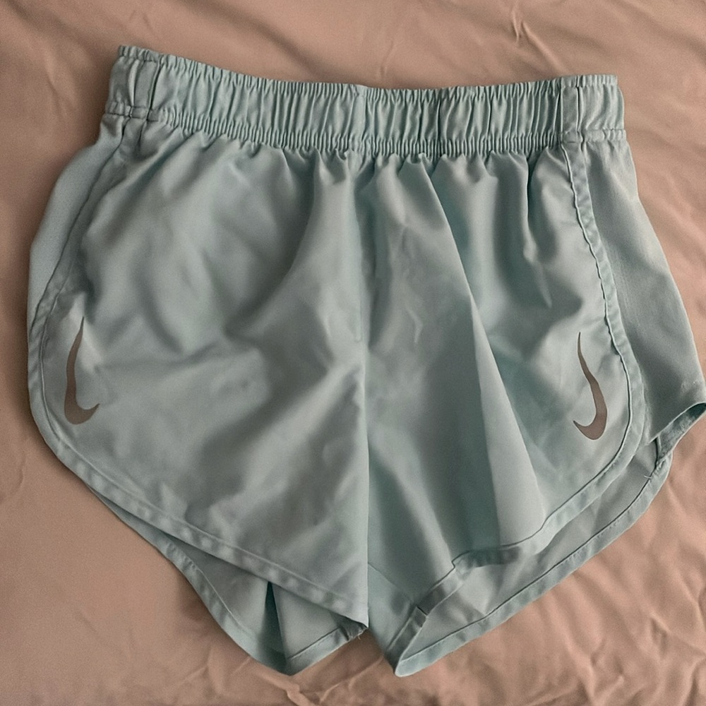 Aqua colored Nike running shorts